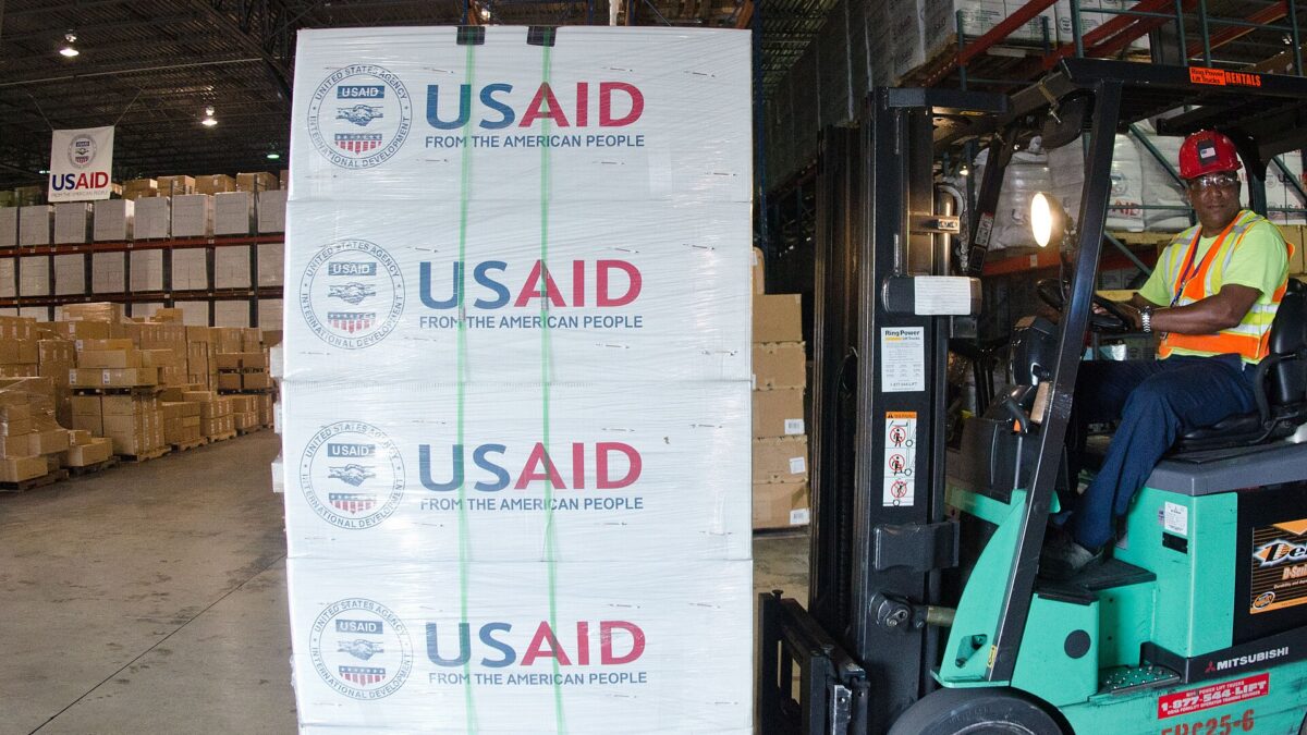 Forklifts moving pallets inside a large logistics warehouse in Miami, Florida